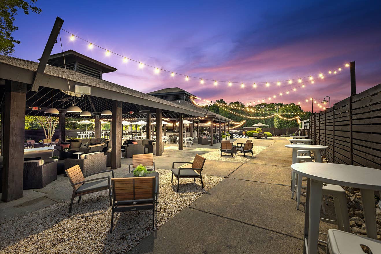 A picture of the outdoor VIP Club area at night with string lights at PNC Music Pavilion. 